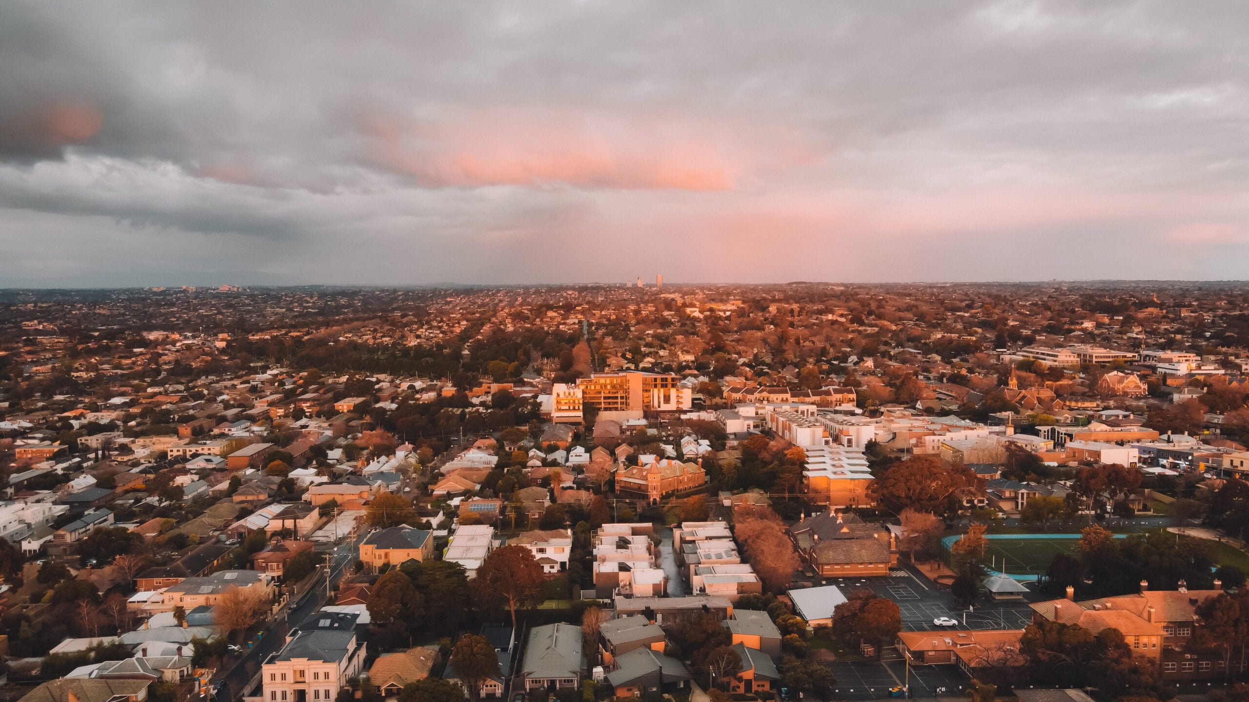 A panoramic view of Australian rooftops and housing at sunset