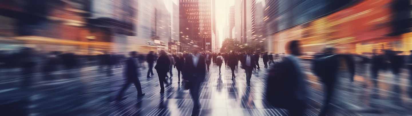 Blurred city crowd walking at sunset.